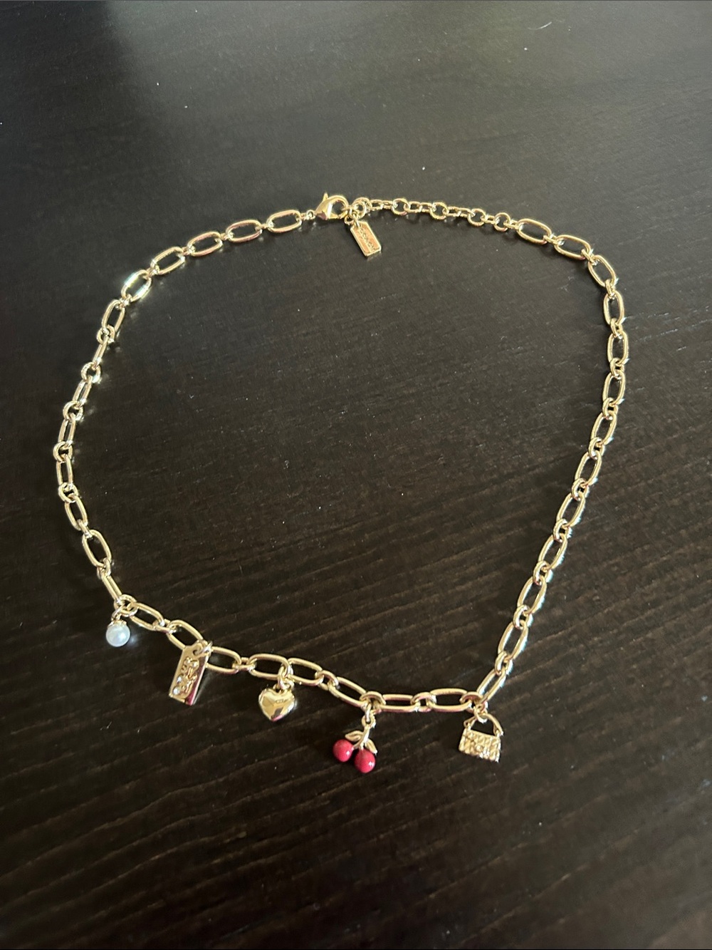 Coach Gold-Tone Charm Necklace with Red Bead and Pearl Accent